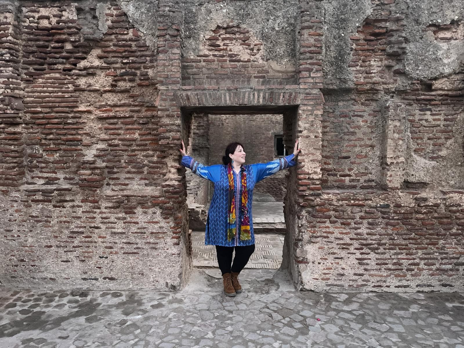 woman in front of brick wall