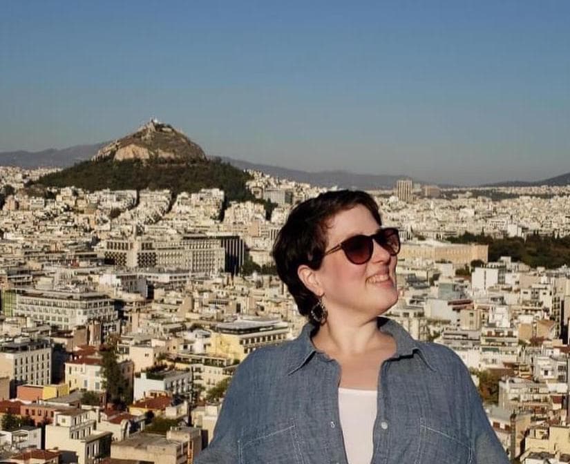 woman in front of greek architecture